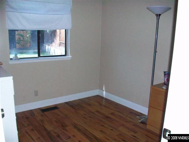 5310 Seville Court Reno, NV 89523 - Photo 8 of 9 an empty room with wooden floor and windows