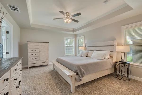 a bedroom with a bed and a tv on the dresser