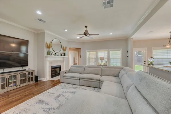 a living room with furniture a flat screen tv and a fireplace
