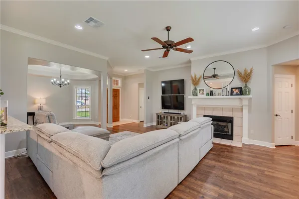 a living room with furniture a fireplace and a large window