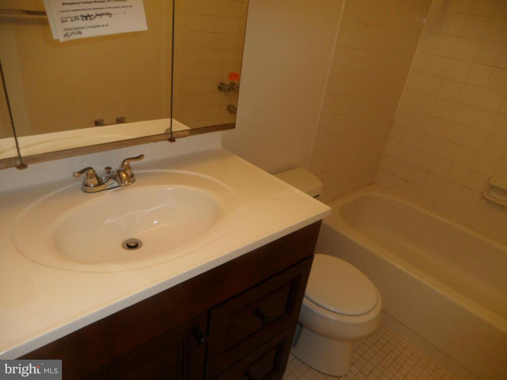 9896 Whiskey Run Laurel, MD 20723 - Photo 9 of 12 a bathroom with a sink a toilet and shower