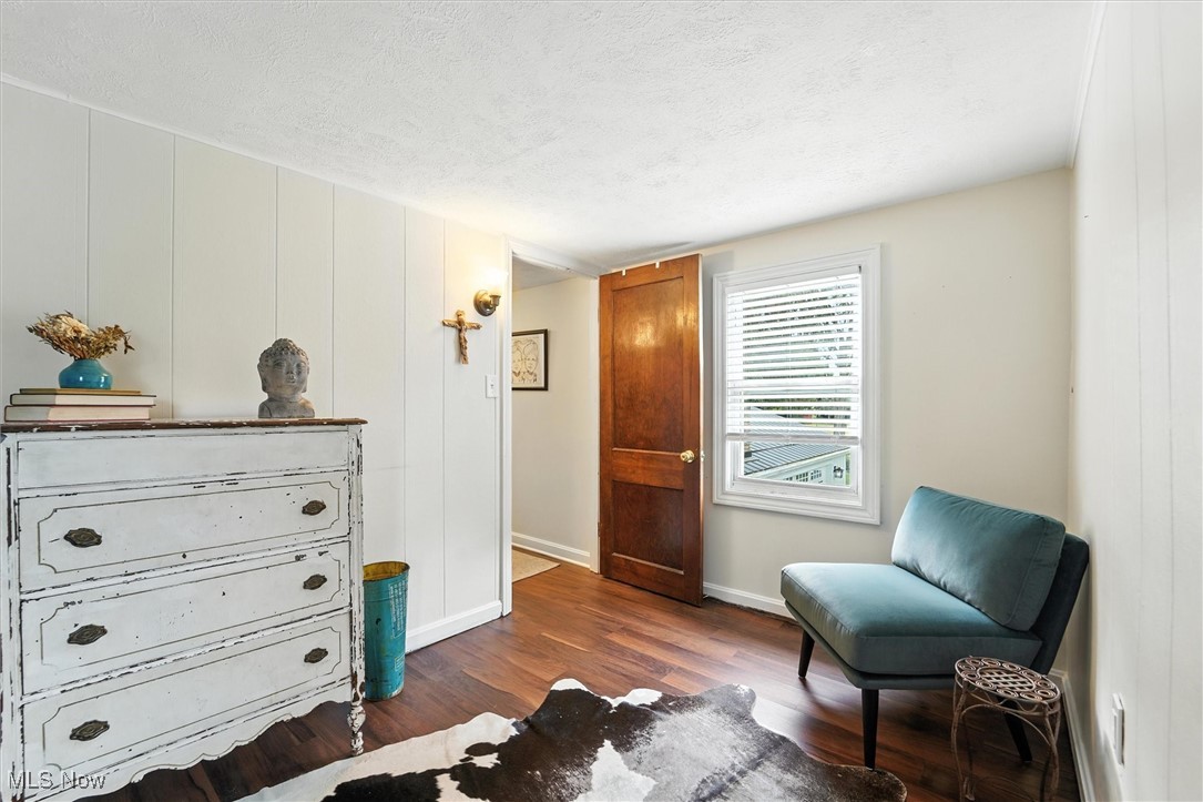194 Ansel Road Geneva, OH 44041 - Photo 34 of 41 Living area featuring a textured ceiling and dark wood finished floors