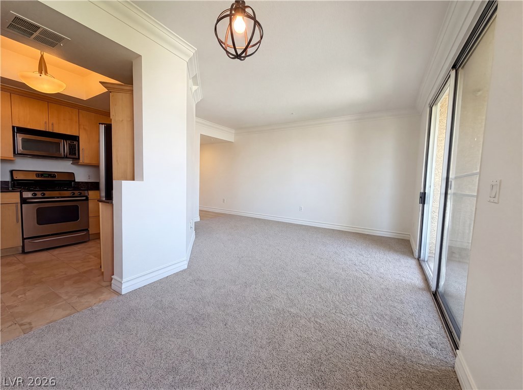230 East Flamingo Road, Unit 320 Las Vegas, NV 89169 - Photo 19 of 19 An open floorplan seamlessly connects the kitchen with stainless steel appliances to the cozy living area with sliding doors.
