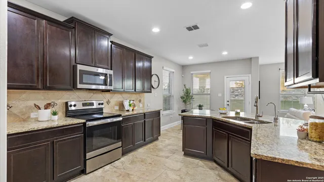 a kitchen with a table and chairs in it