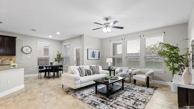 a bedroom with a large bed couch and a window