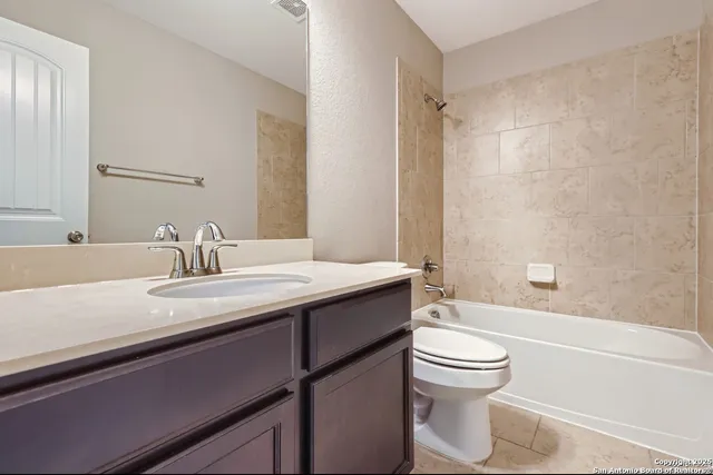 an empty room with closet and a chandelier fan