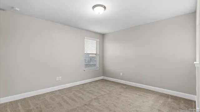 an aerial view of a house with backyard space and swimming pool