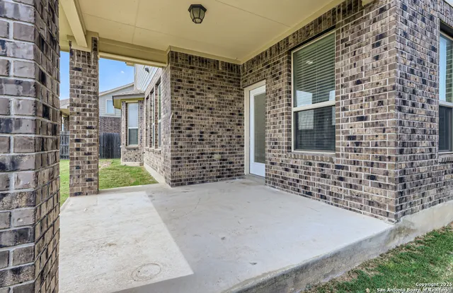 a front view of a house with swimming pool having outdoor seating