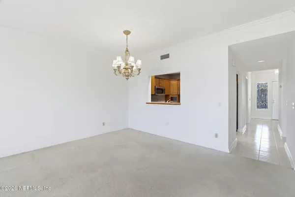 a view of a tennis ground with large trees