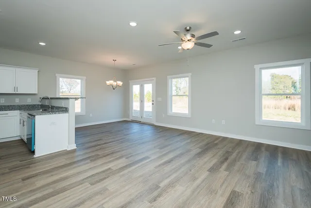 a kitchen with a refrigerator a microwave a sink and cabinets