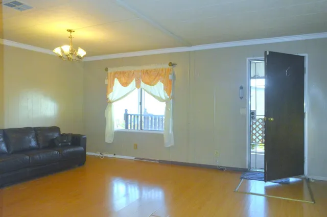 a living room with furniture and a chandelier