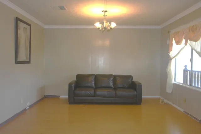 a living room with furniture and a chandelier