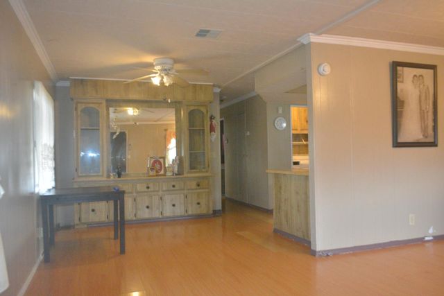a view of a room with wooden floor and a window