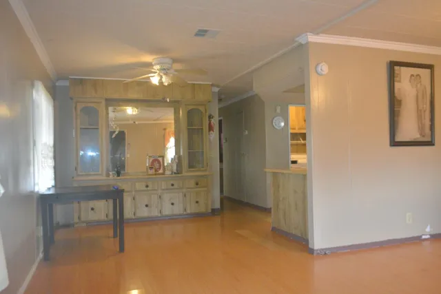 a view of a room with wooden floor and a window