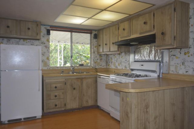 a kitchen with a refrigerator and a sink