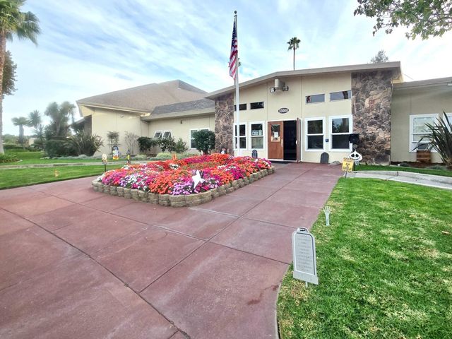 a swimming pool with outdoor seating and yard