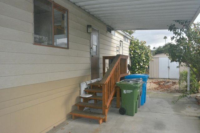 a view of a chair and table in the patio