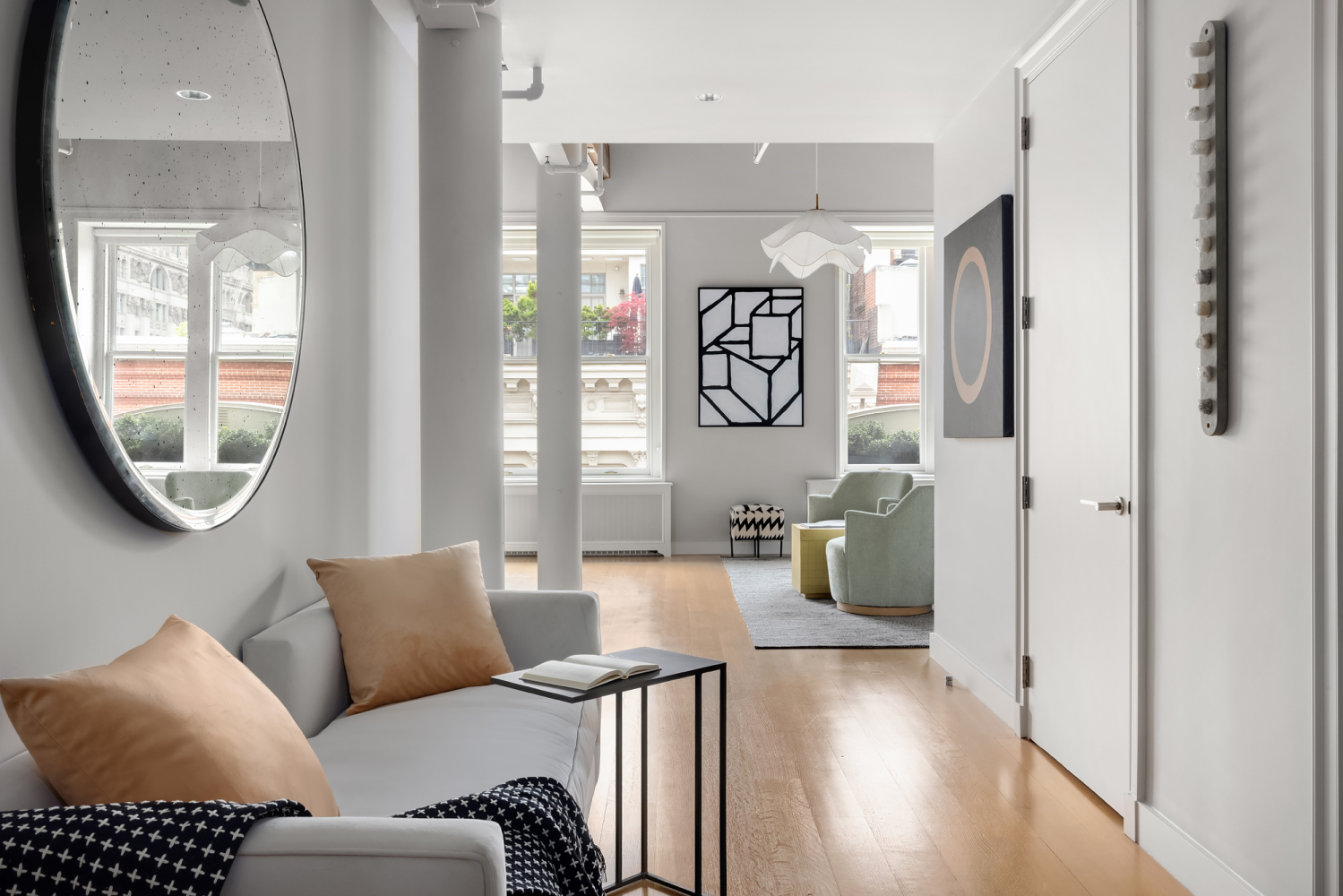 63 Greene Street, Unit PHA Manhattan, NY 10012 - Photo 11 of 20 a living room with furniture a wooden floor and a large window