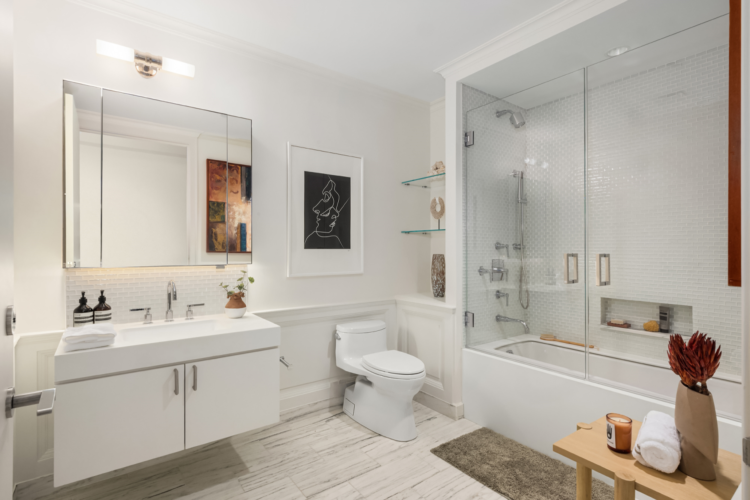 63 Greene Street, Unit PHA Manhattan, NY 10012 - Photo 17 of 20 a bathroom with a double vanity sink toilet mirror and bathtub