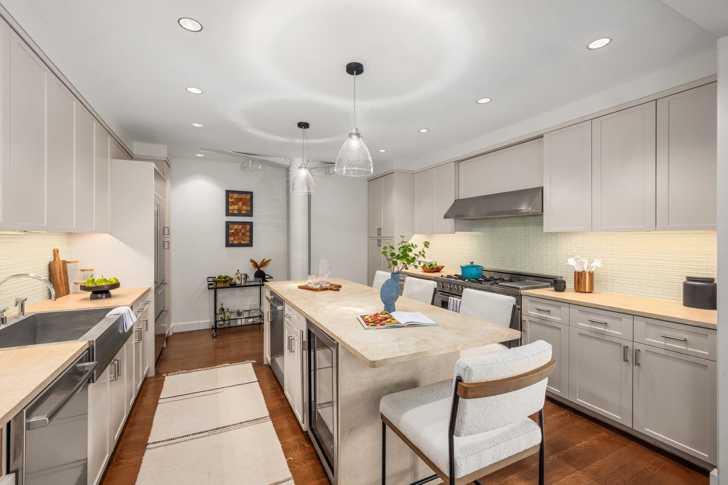 63 Greene Street, Unit PHA Manhattan, NY 10012 - Photo 8 of 20 a kitchen with stainless steel appliances kitchen island granite countertop a sink and cabinets