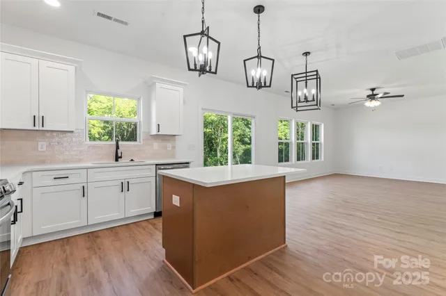 a bathroom with a granite countertop toilet sink and mirror