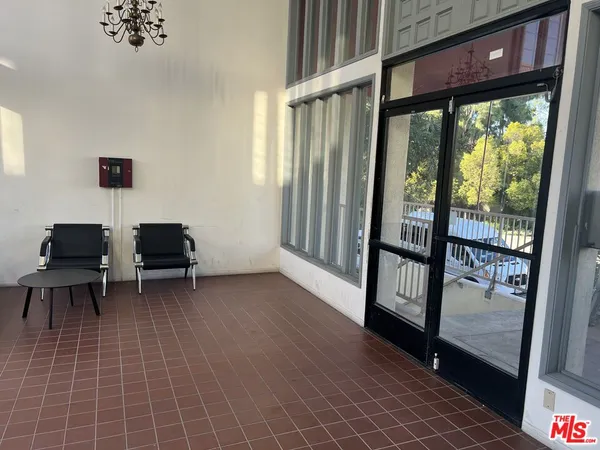 a view of a room with wooden floor and windows