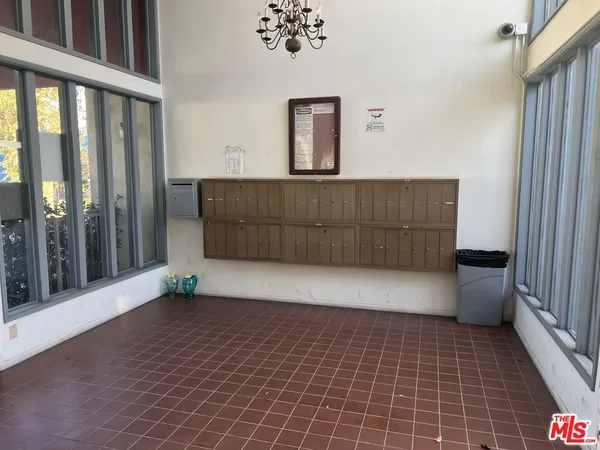 a view of a patio with table and chairs potted plants