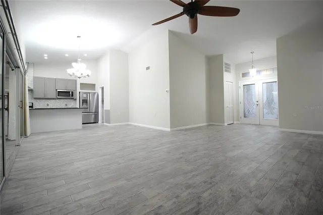 an empty space with closet and a ceiling fan