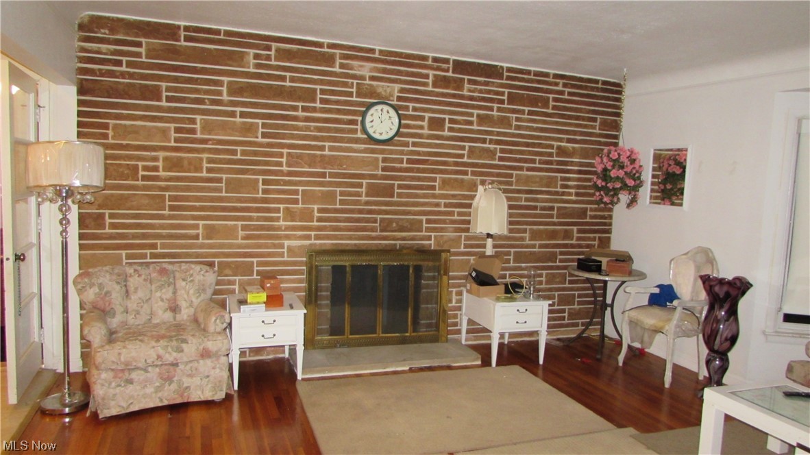 18375 Alexander Road Walton Hills, OH 44146 - Photo 9 of 25 Living room featuring a stone fireplacewood-style floors