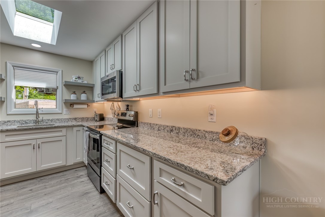 174 Spruce Pine Road Newland, NC 28657 - Photo 12 of 50 a kitchen with a sink cabinets and window