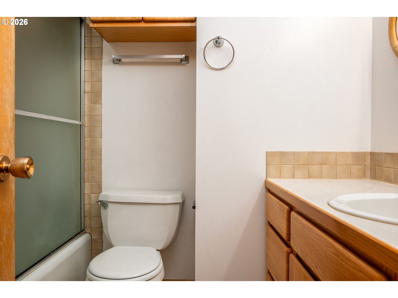 5815 Southwest Huddleson Street Portland, OR 97219 - Photo 11 of 35 a bathroom with a sink a toilet and a mirror