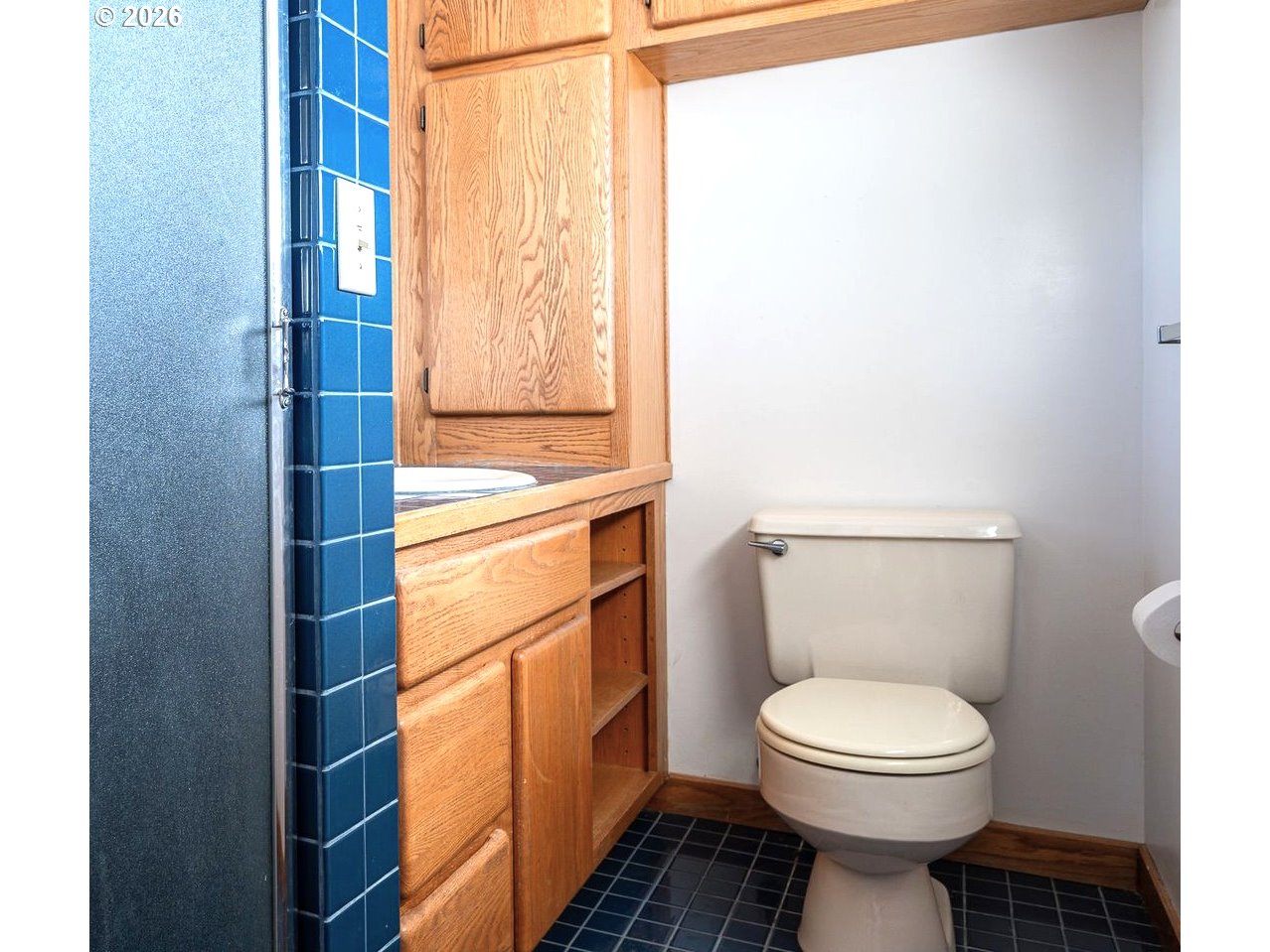 5815 Southwest Huddleson Street Portland, OR 97219 - Photo 14 of 35 a bathroom with a toilet a sink and a window