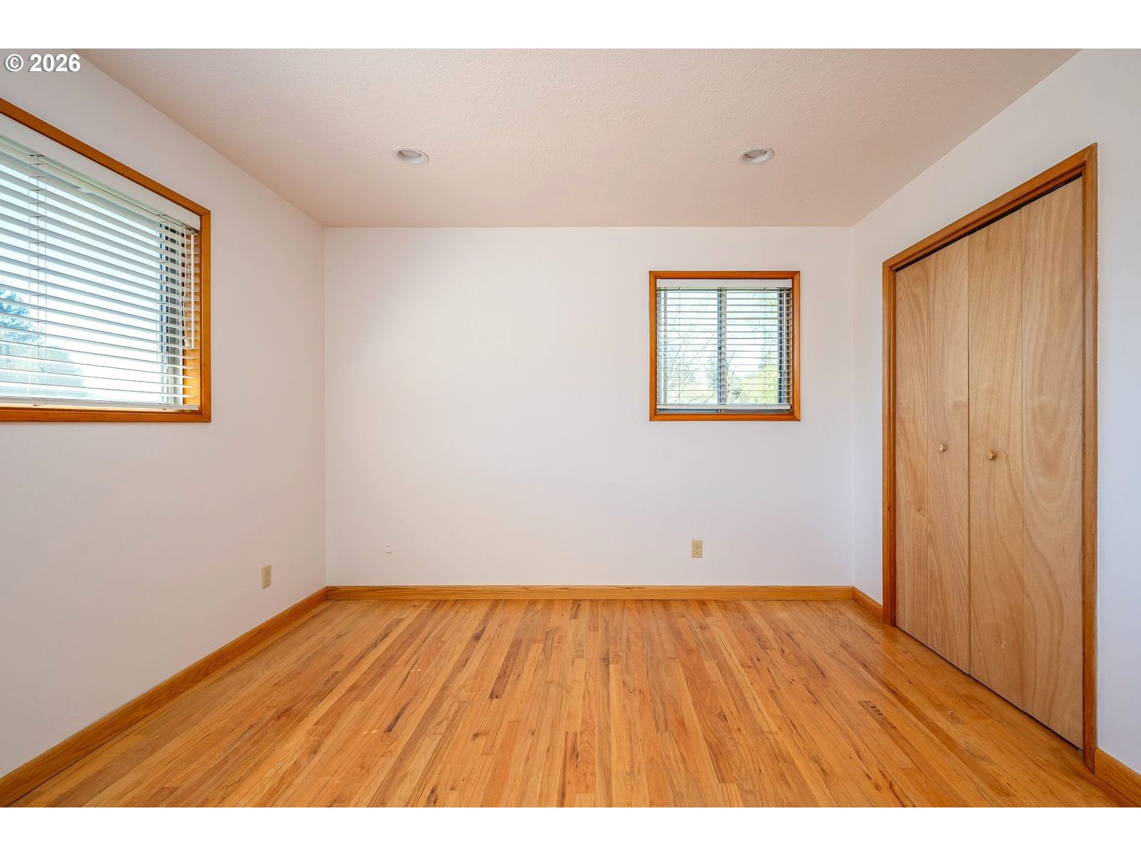 5815 Southwest Huddleson Street Portland, OR 97219 - Photo 15 of 35 a view of an empty room with wooden floor and a window