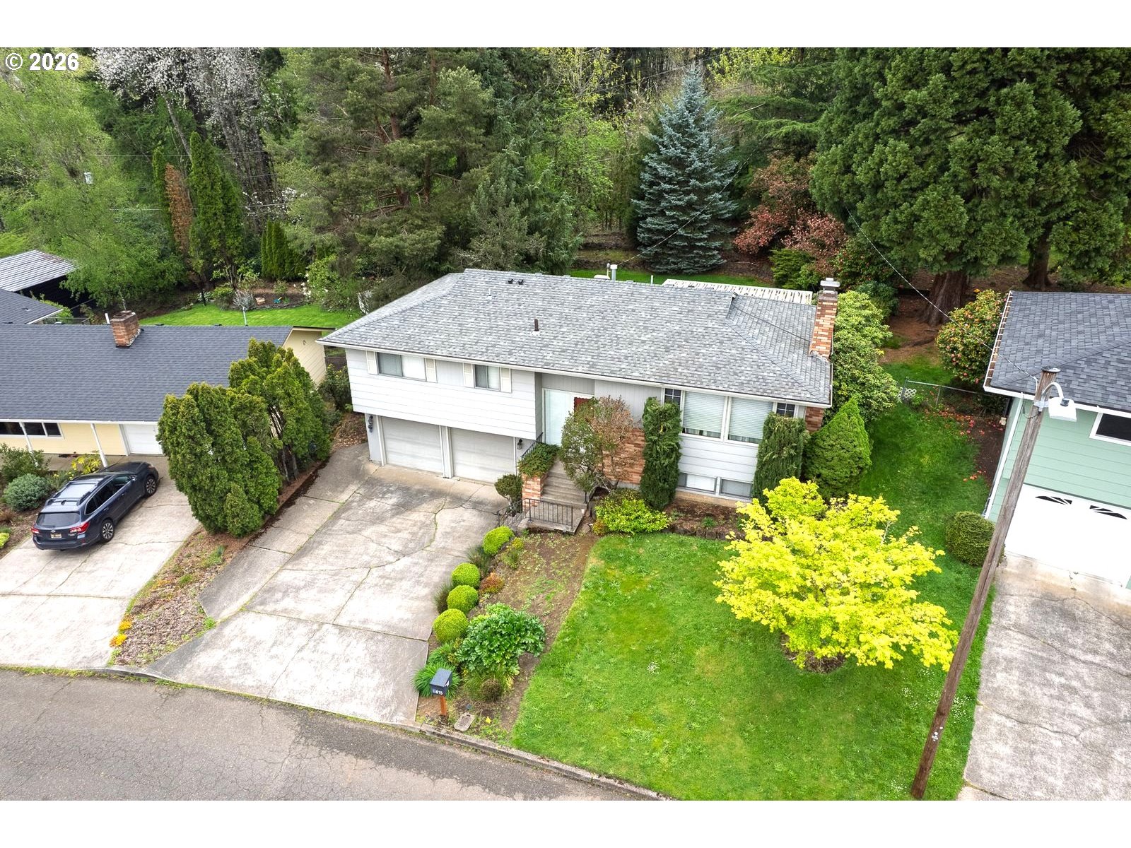 5815 Southwest Huddleson Street Portland, OR 97219 - Photo 28 of 35 a view of a house with a yard and garden