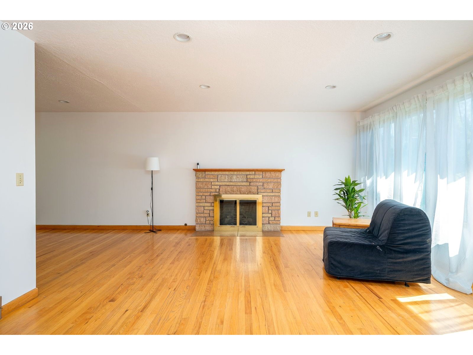 5815 Southwest Huddleson Street Portland, OR 97219 - Photo 5 of 35 a living room with furniture and a fireplace