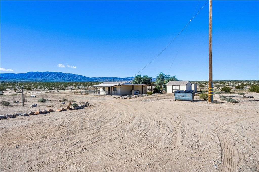 5828 Steeg Road Twentynine Palms, CA 92277 - Photo 54 of 66 a view of a road with a building in the background