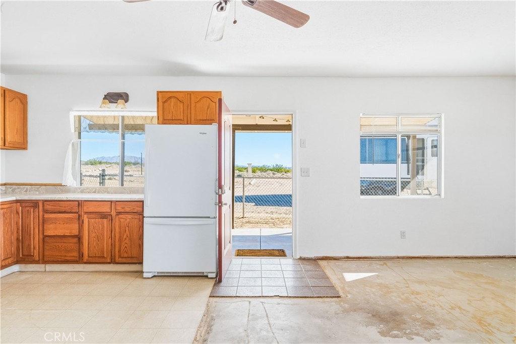 5828 Steeg Road Twentynine Palms, CA 92277 - Photo 7 of 66 a kitchen with stainless steel appliances a refrigerator and a stove top oven