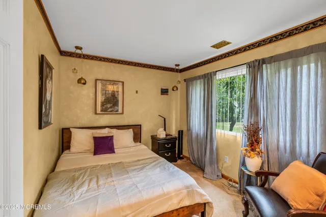 a bedroom with furniture and a window