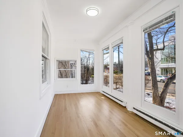 a view of an entryway with wooden floor and door