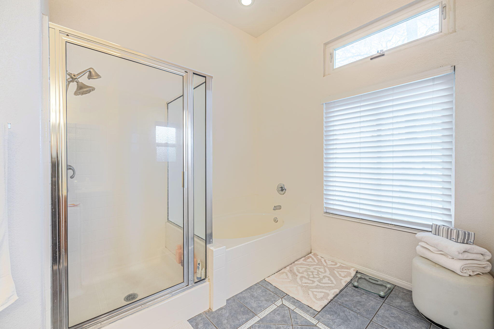 41002 Flagstone Street Palmdale, CA 93551 - Photo 21 of 57 a bathroom with a shower and a bathtub