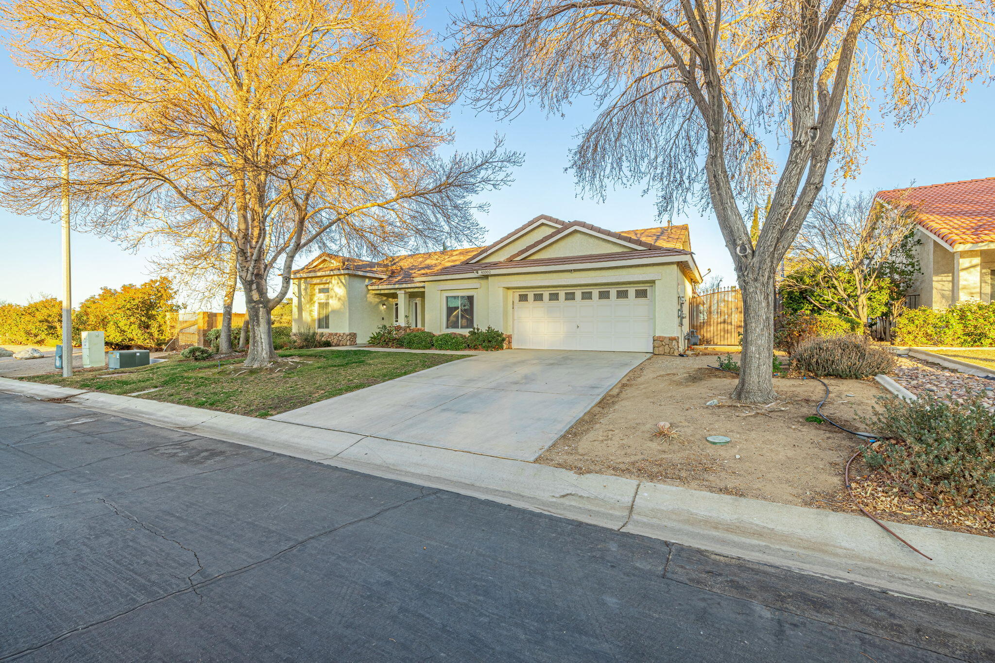 41002 Flagstone Street Palmdale, CA 93551 - Photo 3 of 57 a house with trees in front of it