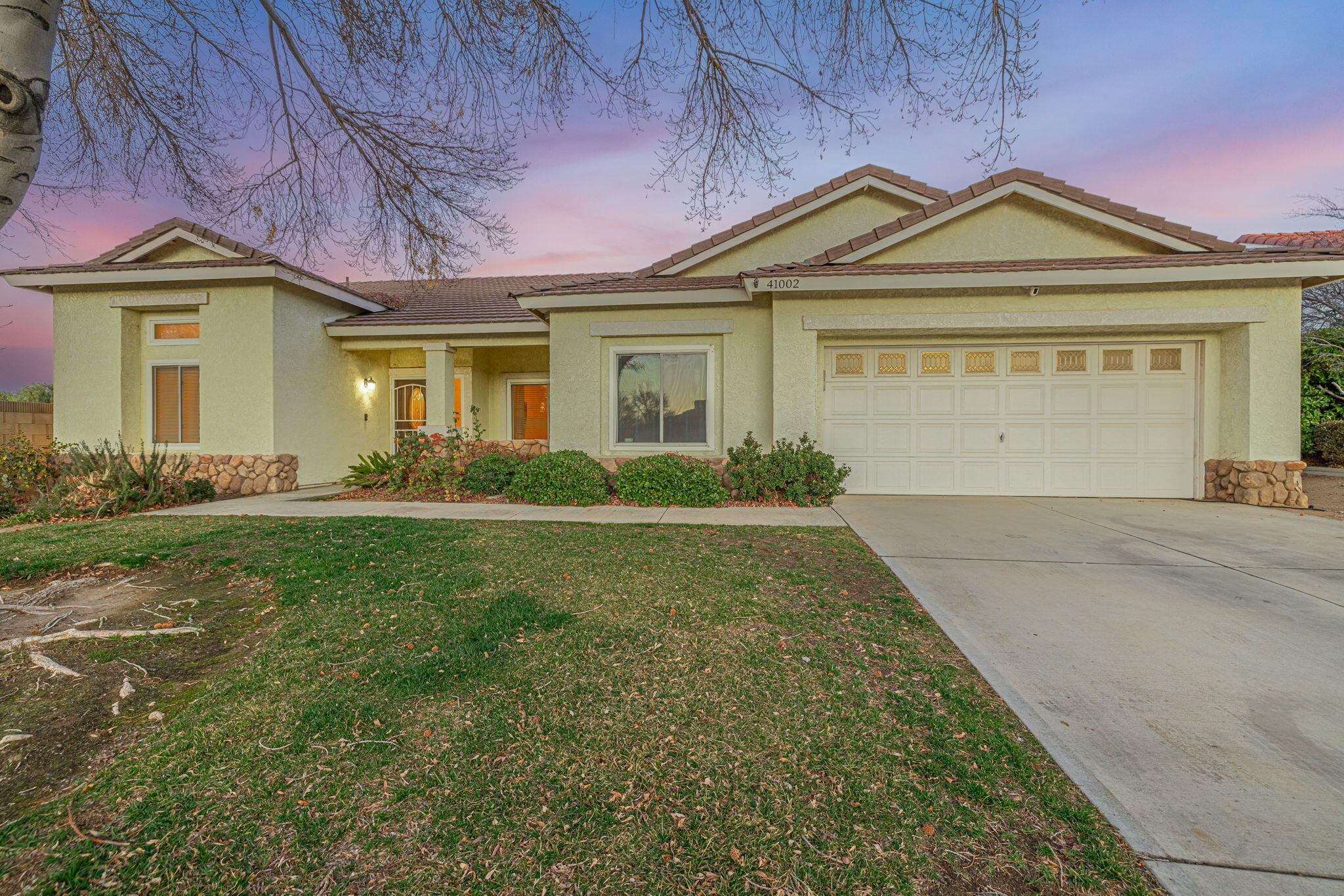 41002 Flagstone Street Palmdale, CA 93551 - Photo 45 of 57 a front view of a house with garden