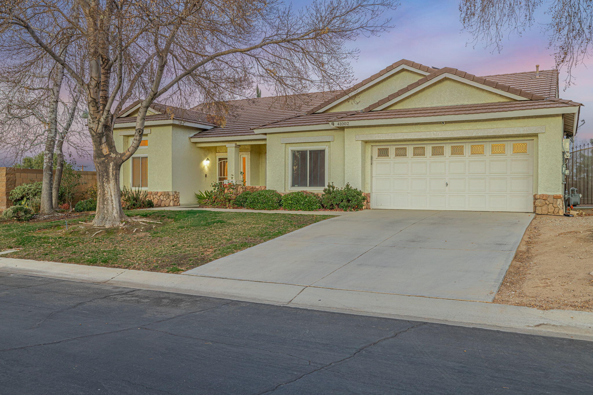 41002 Flagstone Street Palmdale, CA 93551 - Photo 46 of 57 a front view of a house with a yard and garage