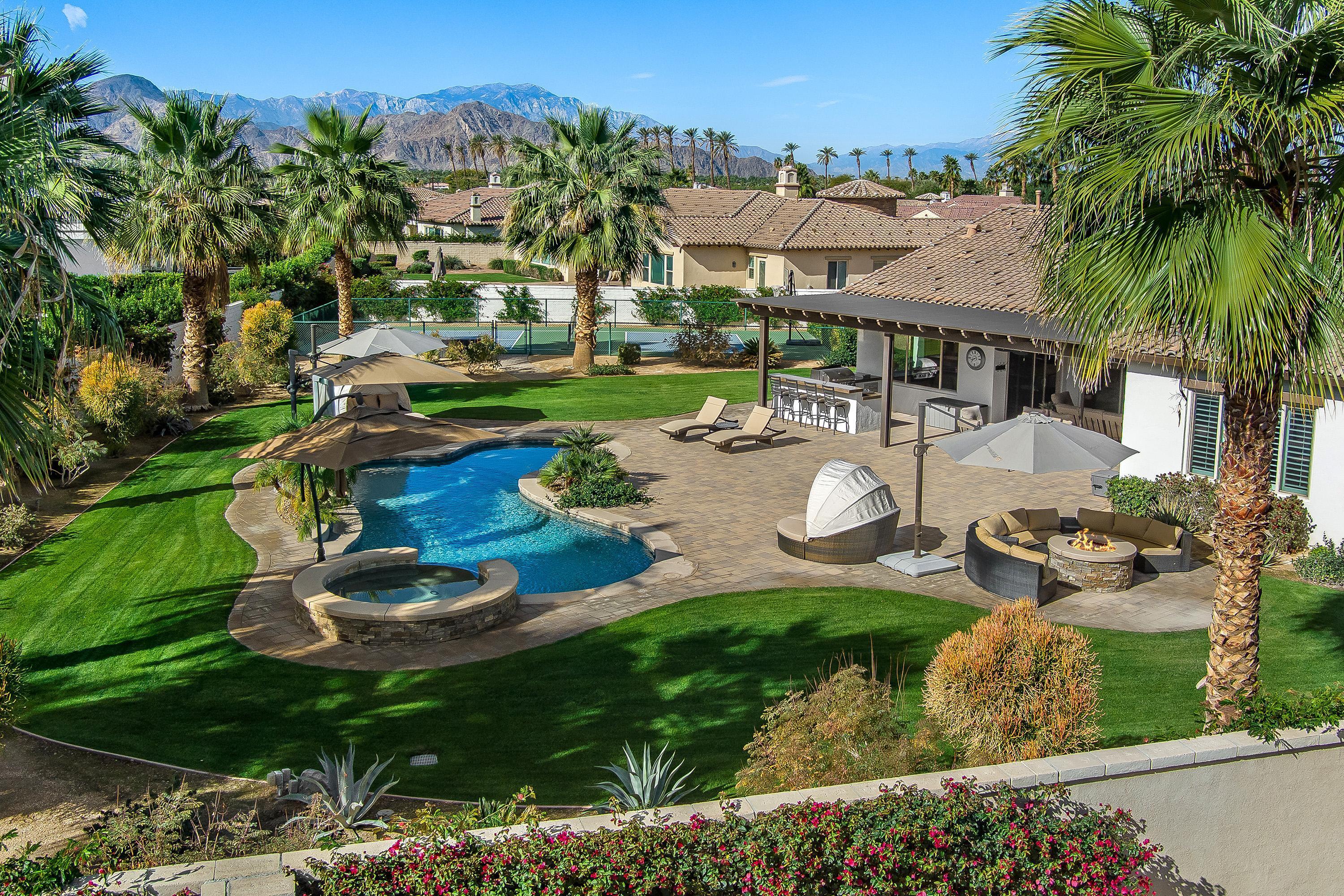 an aerial view of a house with garden space and lake view