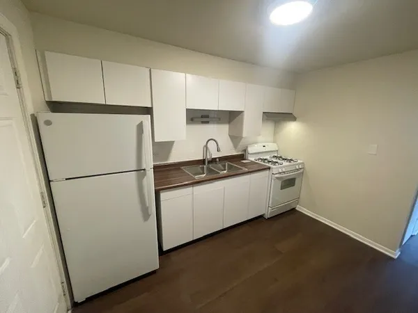a white refrigerator freezer sitting inside of a kitchen