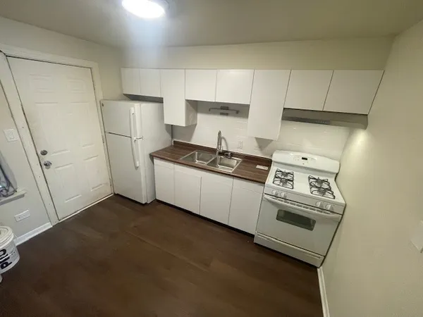 a kitchen with a stove and a refrigerator