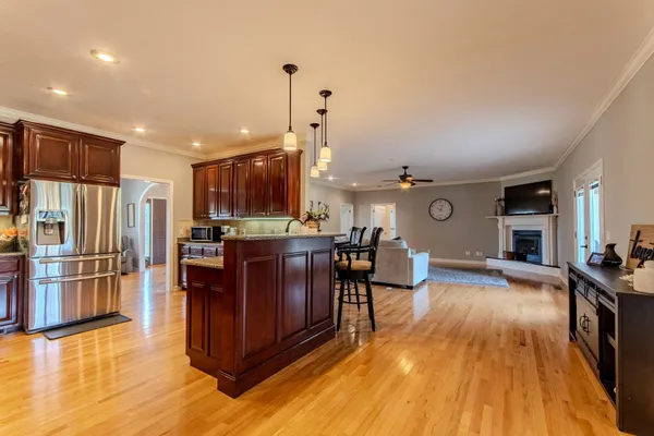 a view of a dining room with furniture a chandelier and wooden floor