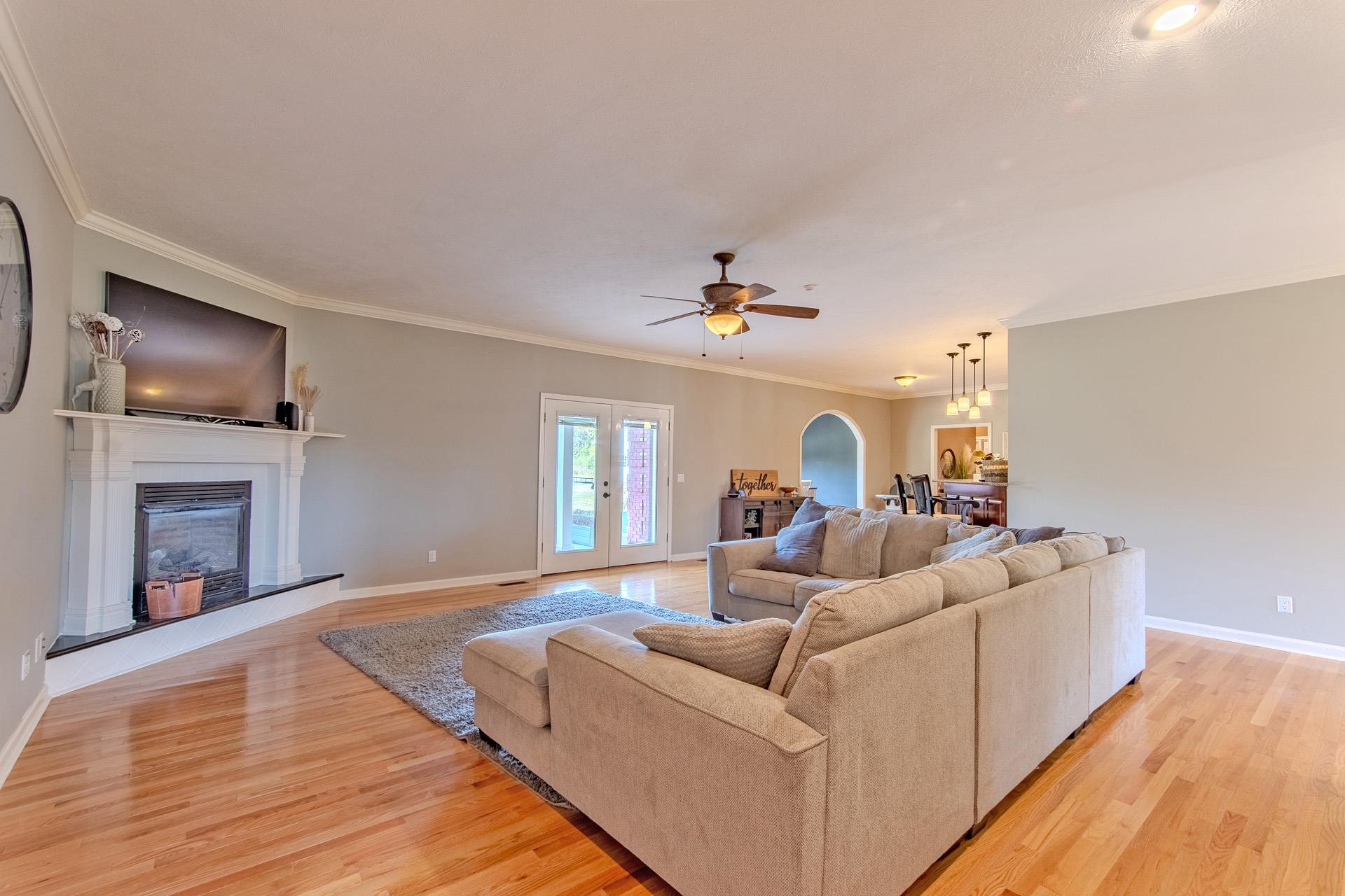 2705 Oak Grove Road Savannah, TN 38372 - Photo 14 of 40 a living room with fireplace furniture and a wooden floor