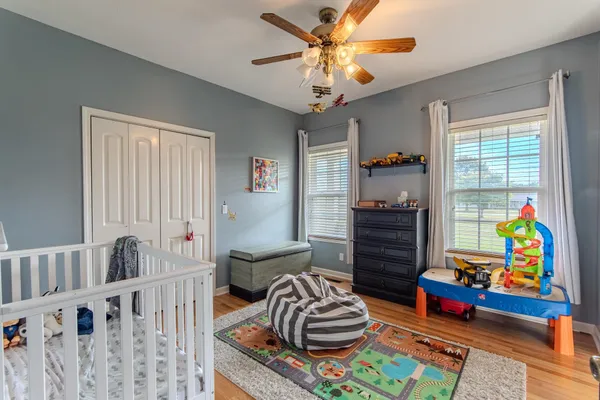 a living room with baby crib furniture and a dining table