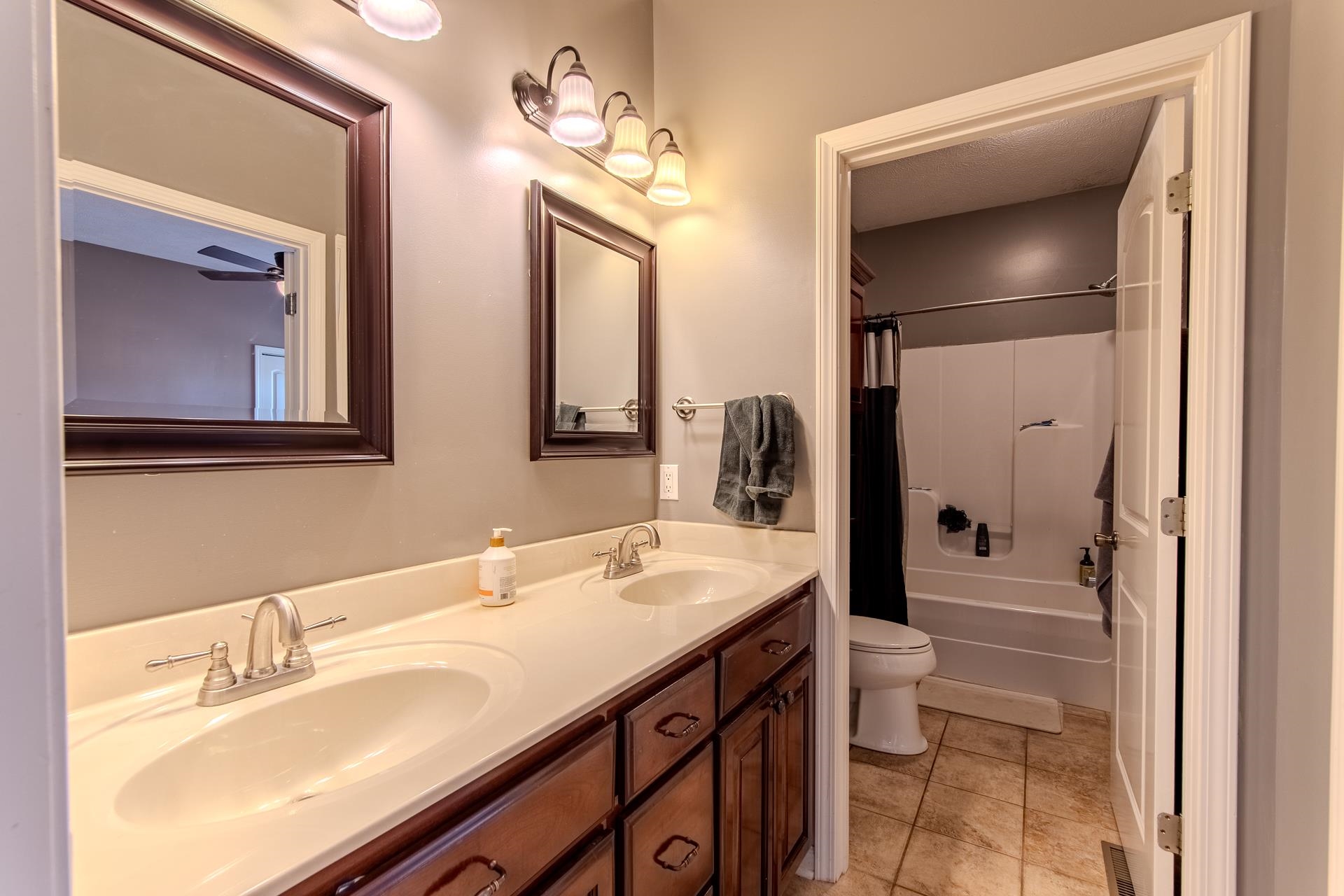 2705 Oak Grove Road Savannah, TN 38372 - Photo 28 of 40 a bathroom with a granite countertop sink a toilet and a mirror